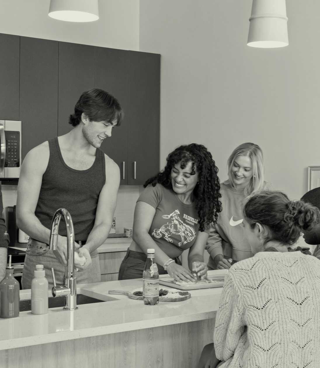 Young adults smiling in a kitchen