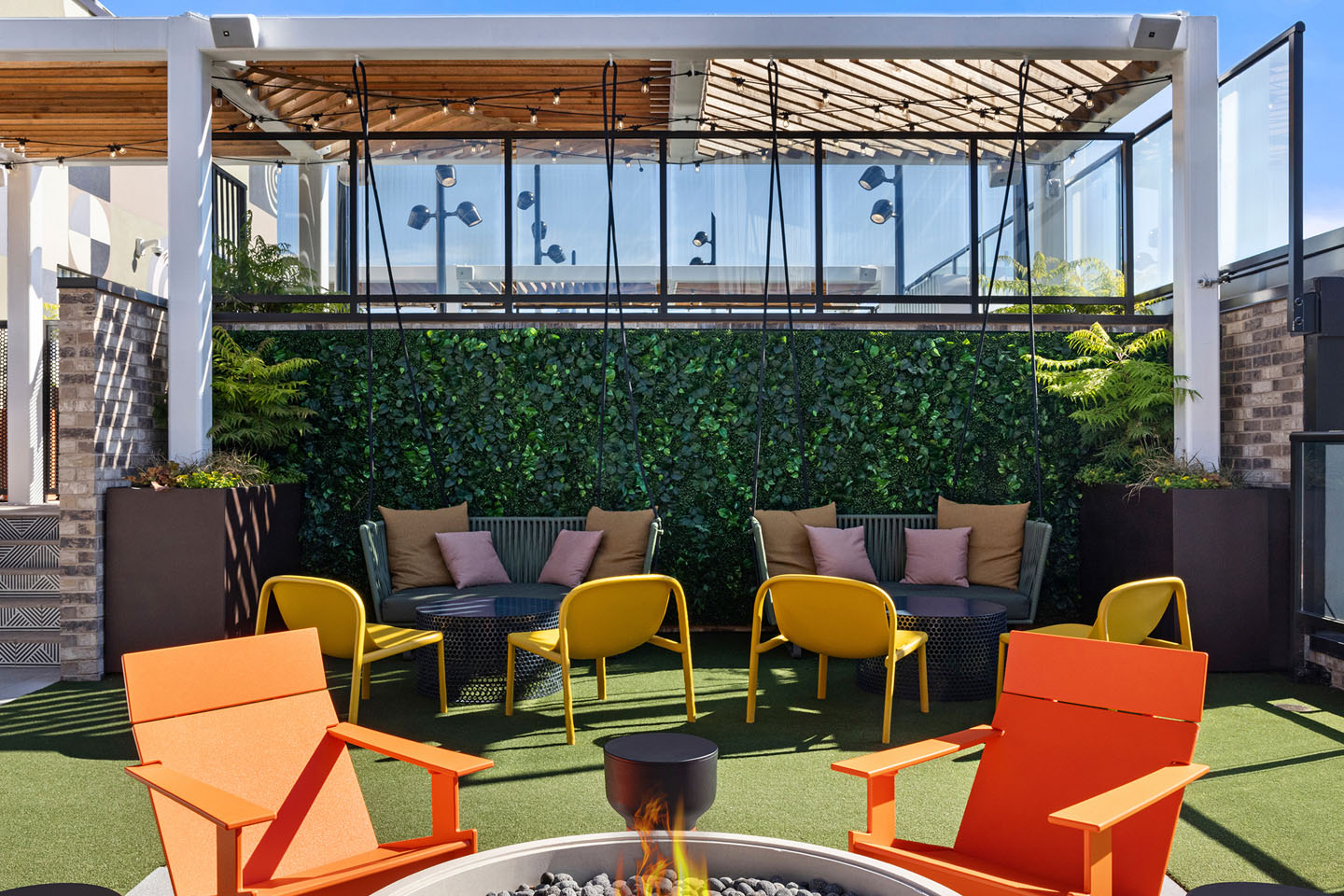 Outdoor lounge area with seating and a fire pit.