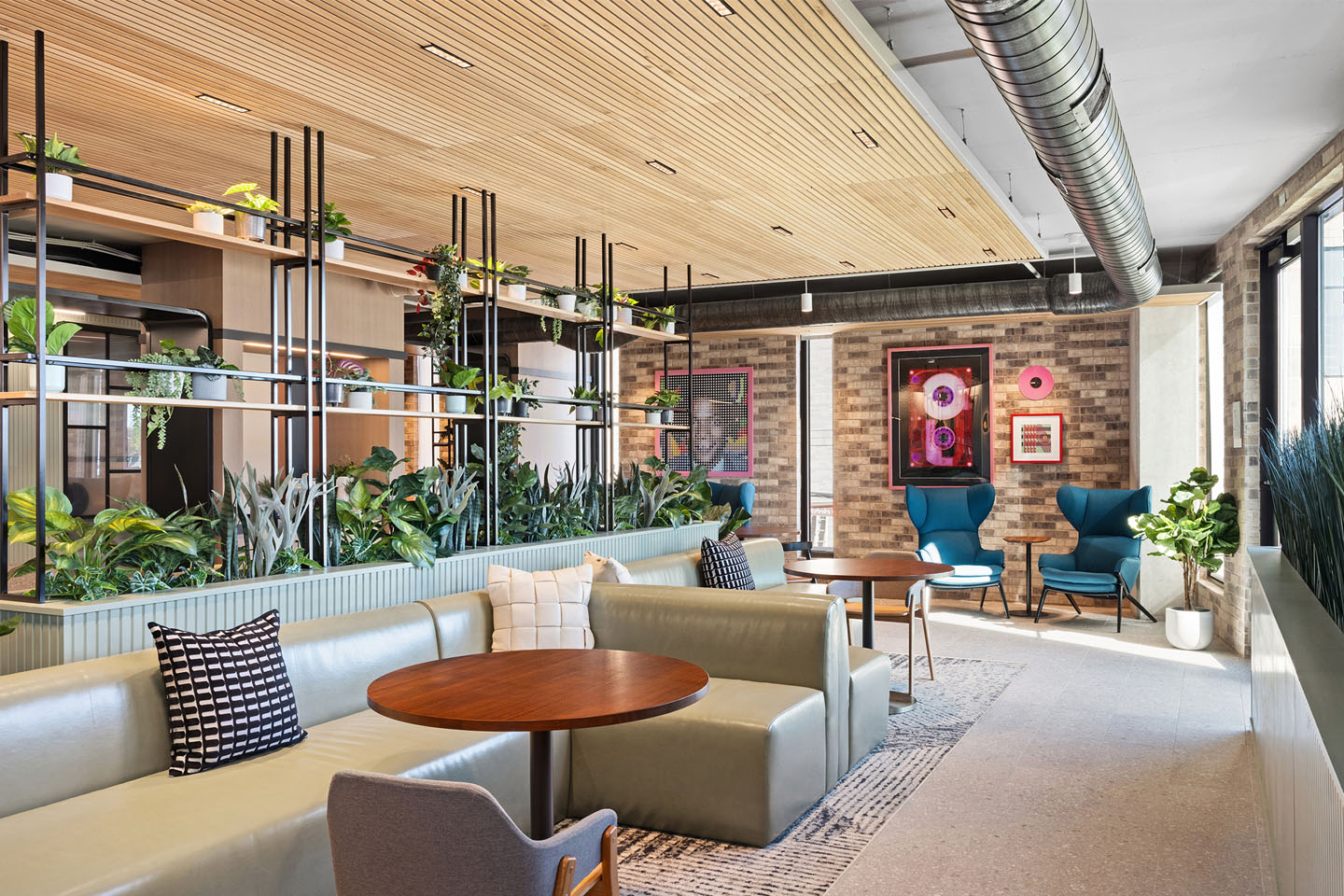 Apartment lobby with comfortable seating and tables.